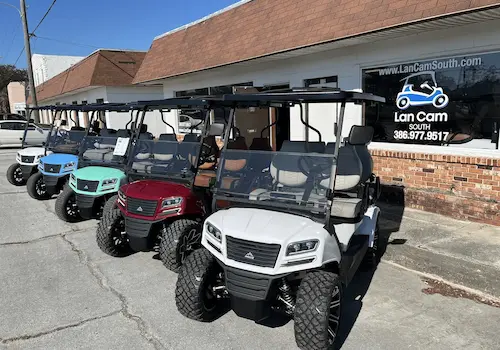 Golf carts lined up outside a shop