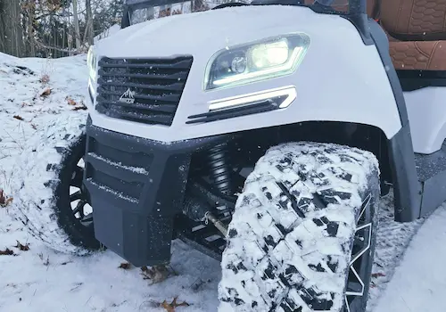 ATV with large tires in snowy landscape