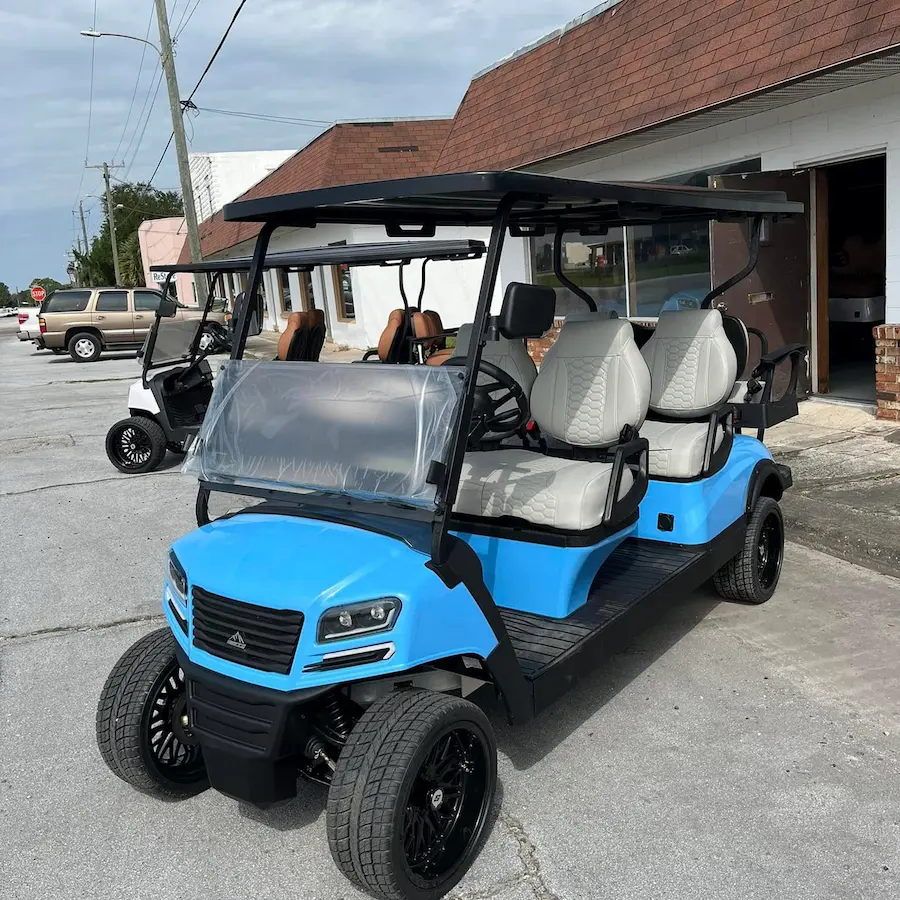 Blue golf cart parked on a driveway