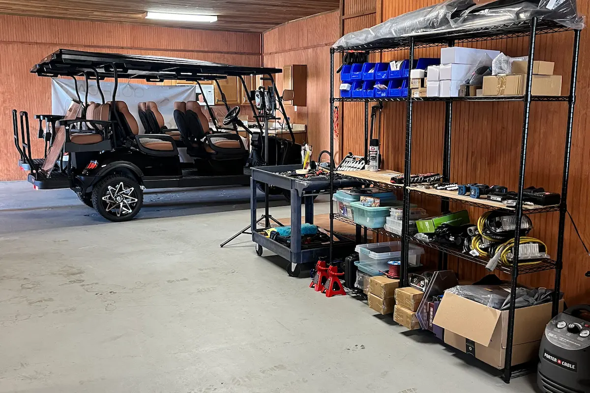 Golf cart parked next to a tool storage area
